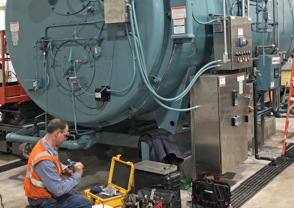 Technician servicing boiler controls