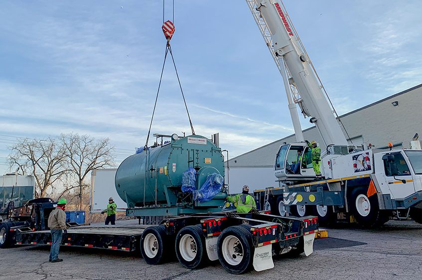 Crane placing boiler equipment during installation