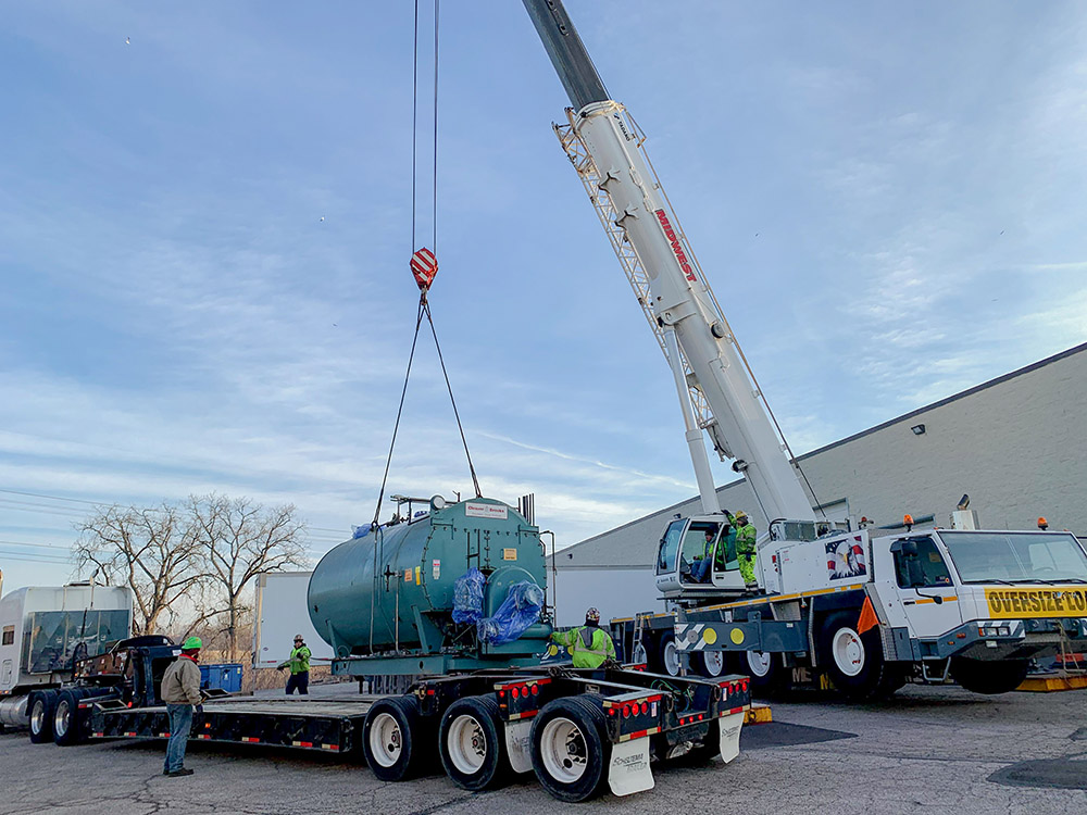 Crane placing boiler equipment during installation